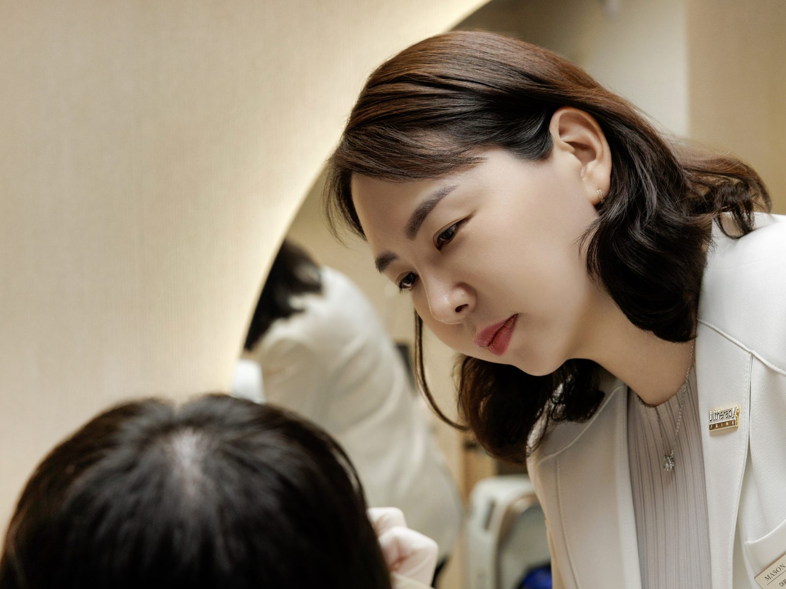 Dr. Kim Hyun-joo checking a face before treatment